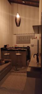 a kitchen with a bird sitting on a table in a room at Vale do Sossego Chalés in Domingos Martins