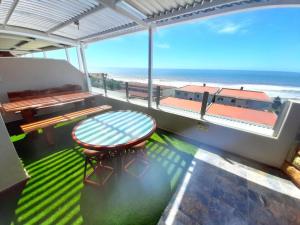 a balcony with a table and a view of the beach at Beach Splendor @ 24 La Crete Sands in Margate