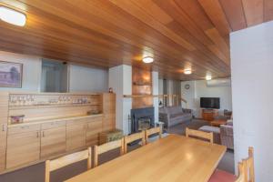 a dining room with a table and a living room at Dauphine 3 23 Townsend Street in Jindabyne