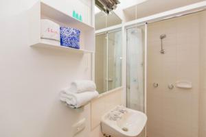 a white bathroom with a sink and a shower at Dauphine 3 23 Townsend Street in Jindabyne +13 photos