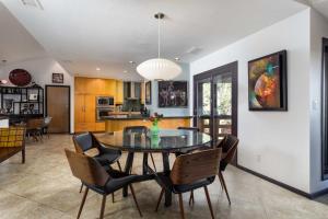 a kitchen and dining room with a table and chairs at Sleek Sedona Abode with Hot Tub and Outdoor Hangout! in Sedona