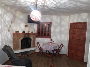 a dining room with a table and a fireplace at Villa de Chino in Monte Verde