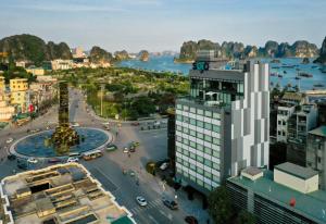 an aerial view of a city with a river and buildings at SOJO Hotel Ha Long in Ha Long