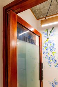 a glass door with a sign on the wall at KenKeSu House-Nice 3rd floor-2BRs-Free airport pick up& drop off from 3 nights in Da Nang +33 photos