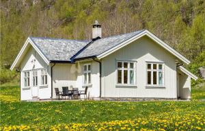 a small white house in a field of flowers at Nice Home In Hemsedal With Sauna in Hemsedal