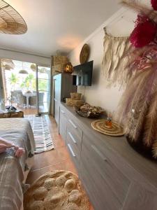 une chambre avec un lit et une cuisine avec un comptoir dans l'établissement LE PARADIS ZEN 1er ETAGE ET RDC VUE PLAGE ET MER STE ANNE, à Sainte-Anne
