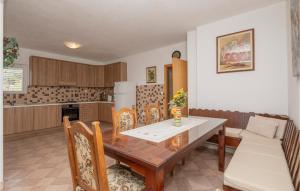 a kitchen with a wooden table and chairs at Gorgeous Apartment In Makarska With Wifi in Makarska
