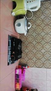 a camera on the floor of a room with a table at Homestay Cikgu Mas in Kodiang