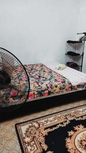 a bed in a room with a rug on the floor at HOMESTAY UMI KODIANG in Kodiang