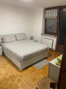 a bedroom with a bed and a television in it at Appartamento G&G in Pontechianale