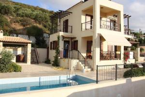 a house with a swimming pool in front of it at Villa Seashell, Private Pool and Magnficent View in Ravdhoúkha