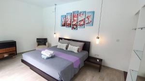 a bedroom with two beds with white pillows on them at Villa Oceana I - 3BR private villa with pool in Legian