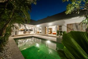 a swimming pool in the backyard of a house at Tides Seminyak in Seminyak