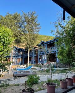 a blue building with a picnic table in front of it at Olympos Route 66 Pansiyon in Olympos