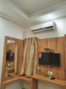 a room with a flat screen tv and a window at Stay Court - Business Class Hotel - Near Central Railway Station in Chennai