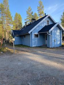 una casa azul con techo negro en Arctic-maja A en Kittilä