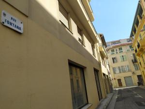 a building with a sign on the side of it at Le Fontana in Nice