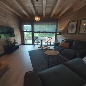 a living room with a couch and a table at Casa con jardín Sallent in Sallent de Gállego