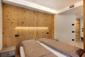 a bedroom with wood paneled walls and a bed at Wind Mountain Planet Suite House in Livigno