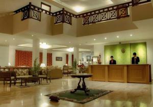 a lobby with a man standing in the middle of a building at The Chumbi Mountain Retreat & Spa in Pelling
