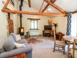 a living room with a couch and a table at Goal Farm Cottage in Skipton