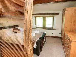 a bedroom with a bunk bed in a room at Goal Farm Cottage in Skipton