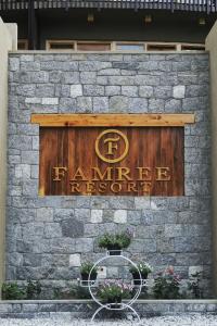 a stone wall with a sign for a farmers store at Famree Resort Hunza in Hunza Valley