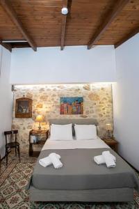 a bedroom with a bed with two towels on it at Malama's maisonette at the historic center in Heraklio