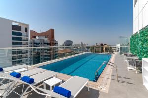 a swimming pool on the roof of a building at Studio M Al Barsha Hotel by Millennium in Dubai