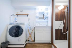 a washing machine in a kitchen with a sink at THE HARMONY in Sapporo