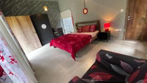 a bedroom with a bed with a red blanket at Antharyamin in Trivandrum