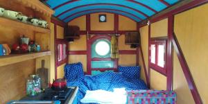 a living room with a couch in a train car at Shepherd's hut in nature in Vojnić