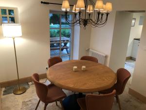 a dining room with a wooden table and chairs at La ferme de Planchevienne in Magny-Cours +41 photos