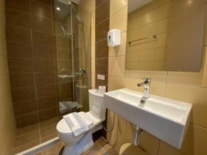 a bathroom with a sink and a toilet and a shower at Angela Hotel & Apartments in Gouvia
