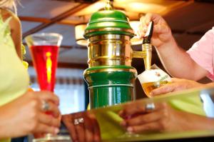 a group of people sitting at a bar with a drink at Appartments Jägerhof in Valdaora