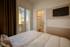Posteľ alebo postele v izbe v ubytovaní Hotel Delfino