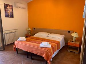 a bedroom with a bed with two towels on it at Villa Bella Vista in Capo Vaticano