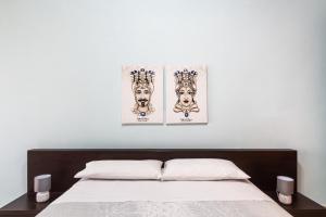 a bedroom with two posters on the wall above a bed at Corte dei Mori in Avola