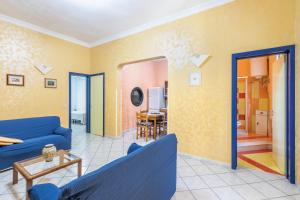a living room with a blue couch and a table at Corte dei Mori in Avola