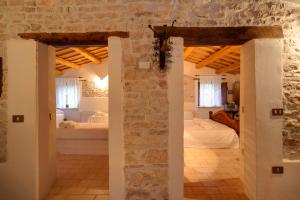 a large room with a bedroom and a bed at Riserva Privata San Settimio in Arcevia