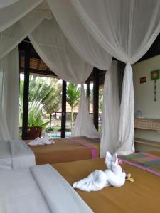 Postelja oz. postelje v sobi nastanitve Taman Bintang Villa Ubud