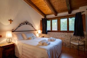 a bedroom with a large bed with towels on it at Riserva Privata San Settimio in Arcevia +90 photos