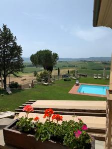a view of a garden with flowers and a pool at Il Montelletto in Santa Luce