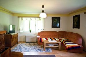 a living room with a couch and a table at Holiday Home 'Pekovo 1825' in Ljubno