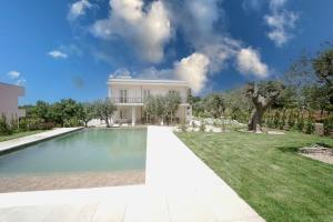 a house with a swimming pool in a yard at ALMASOL - Charme Experience in Castellana Grotte