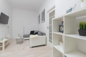uma sala de estar com prateleiras brancas e um sofá em Business District 2 Bedroom Apartment for 5 Guests Gdansk Wrzeszcz by Renters em Gdansk