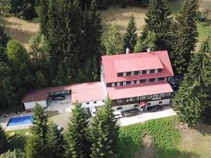 an aerial view of a building with a red roof at Hotel Flora Dolní Mísečky in Dolni Misecky