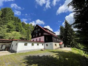 a large black and white building with a yard at Hotel Flora Dolní Mísečky in Dolni Misecky +45 photos
