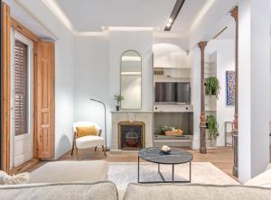 a living room with a couch and a fireplace at City Center modern apartment for 4 SANTA TERESA II in Madrid