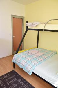 a bunk bed in a room with a door at Apartman Vinkov's center in Jajce